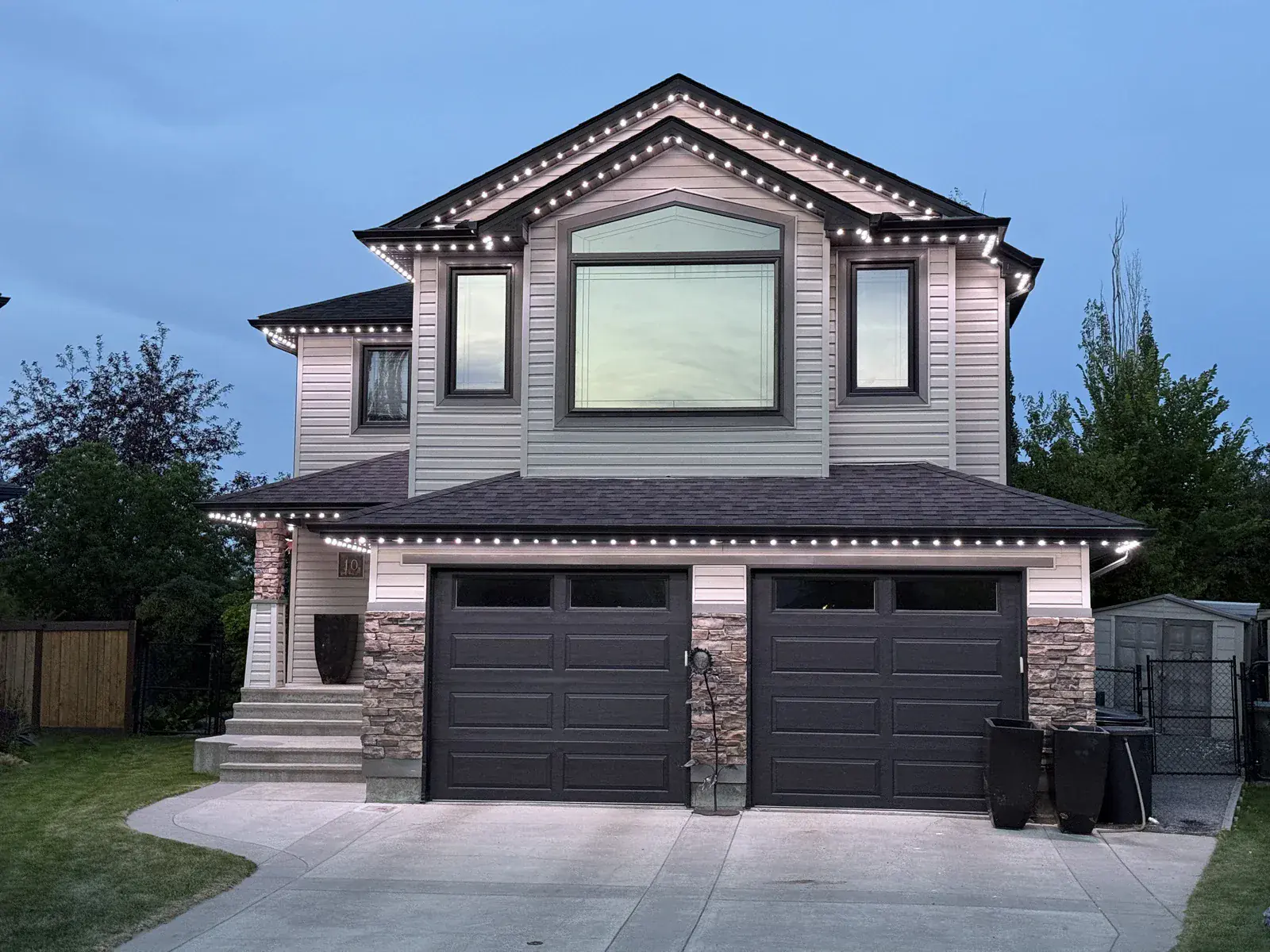 Edmonton home with warm white permanent outdoor lighting