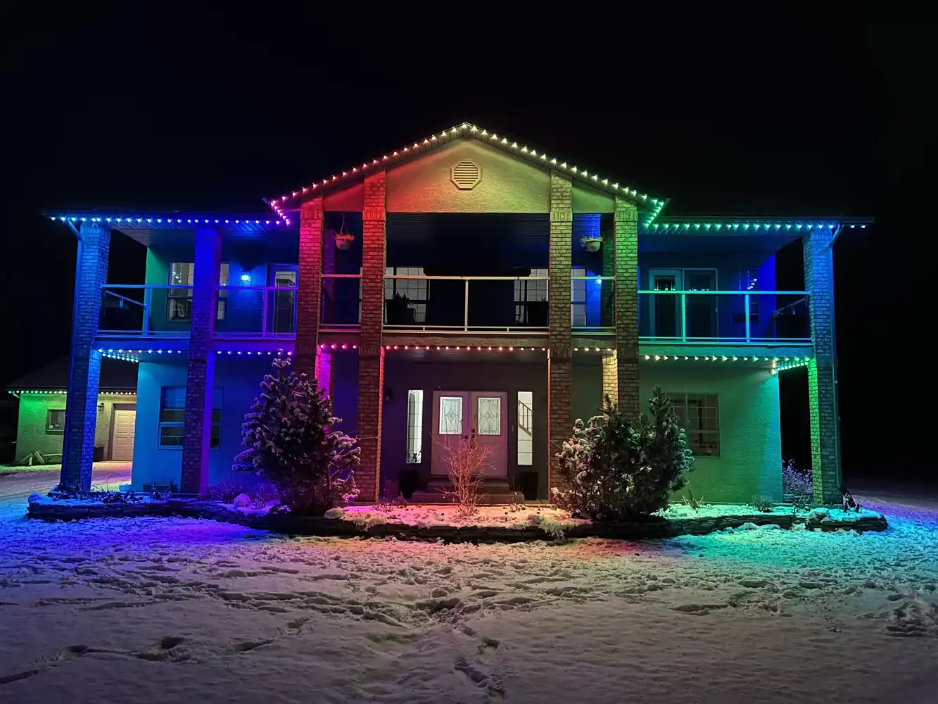Rainbow permanent Christmas lighting display on an Edmonton home
