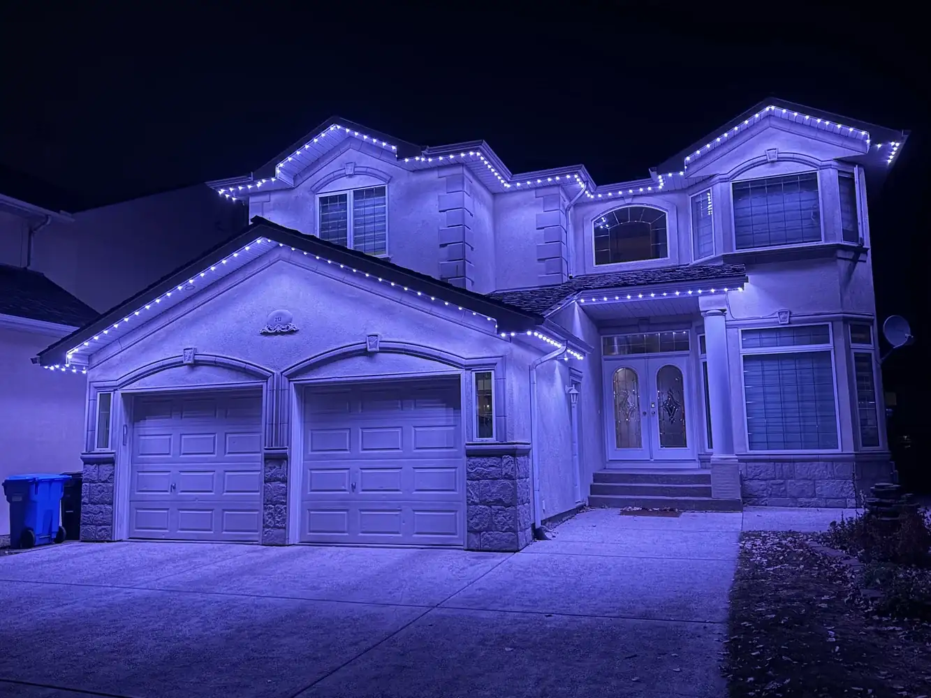 Soft-white permanent lighting scene on an Edmonton home