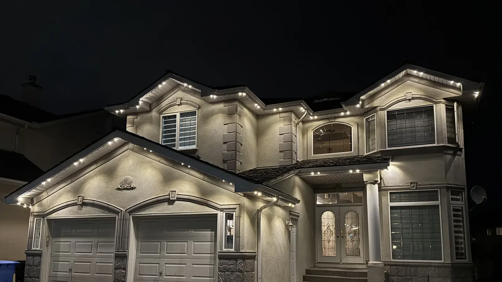 Warm-white permanent lighting scene on an Edmonton home