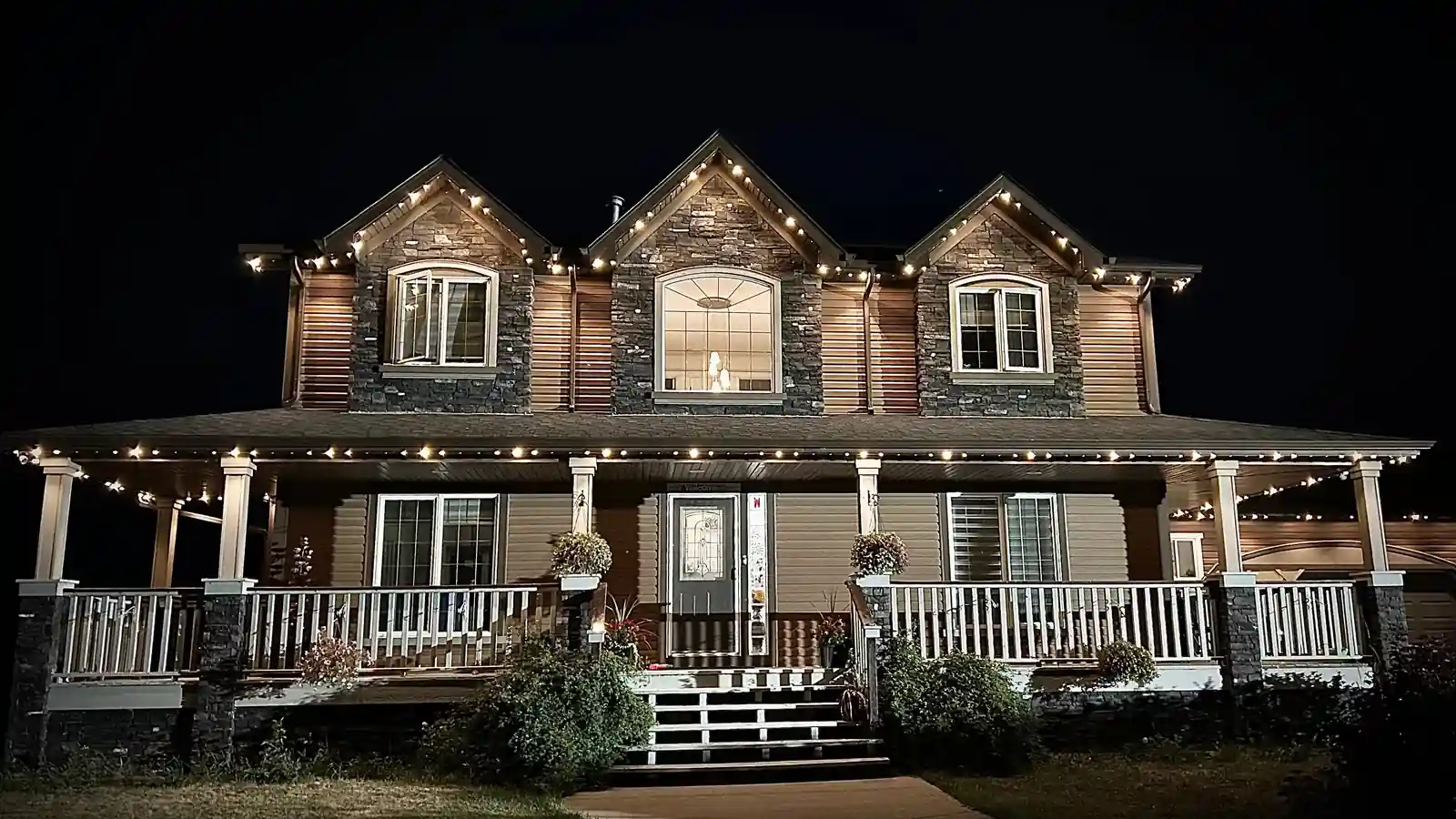 Warm-white permanent Christmas lighting on an Edmonton home