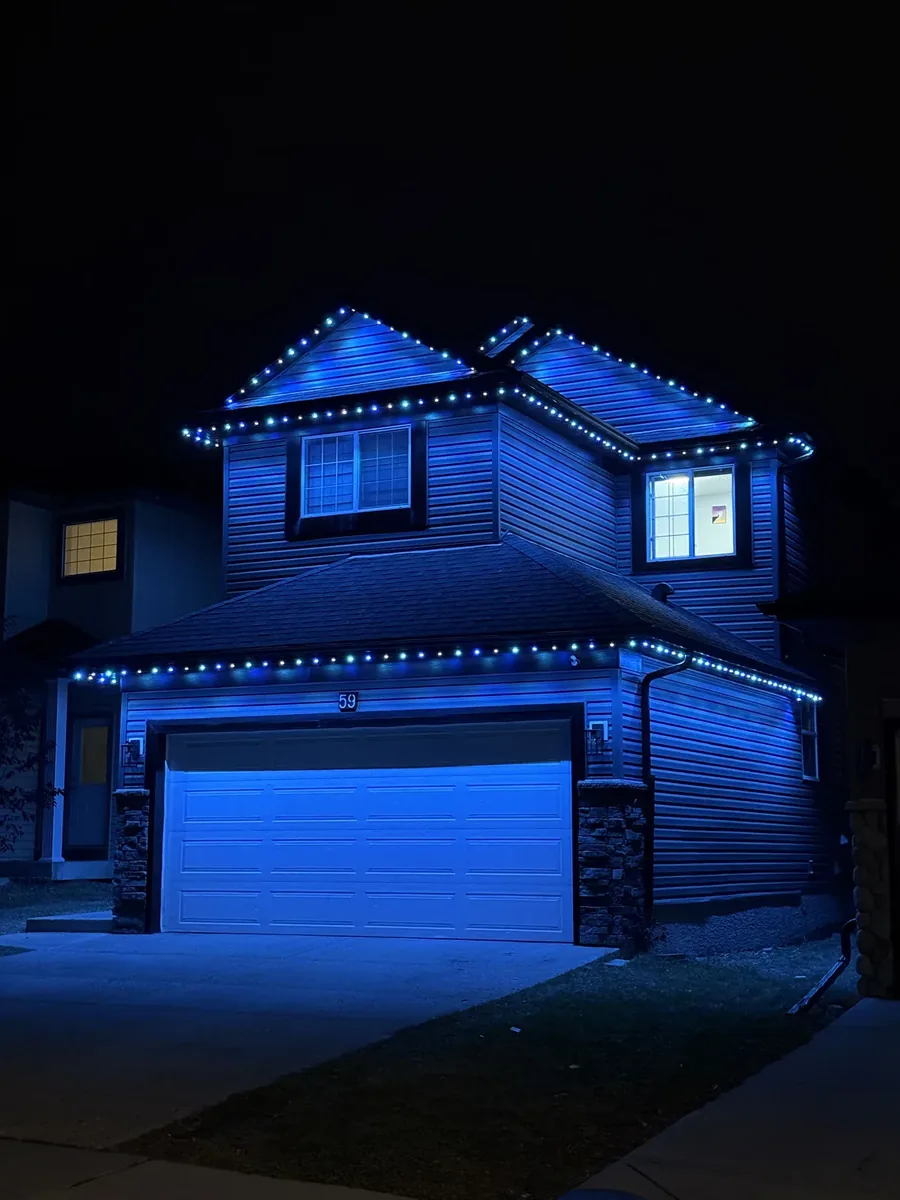 Edmonton home illuminated in cool indigo with the Prairie Lighting system