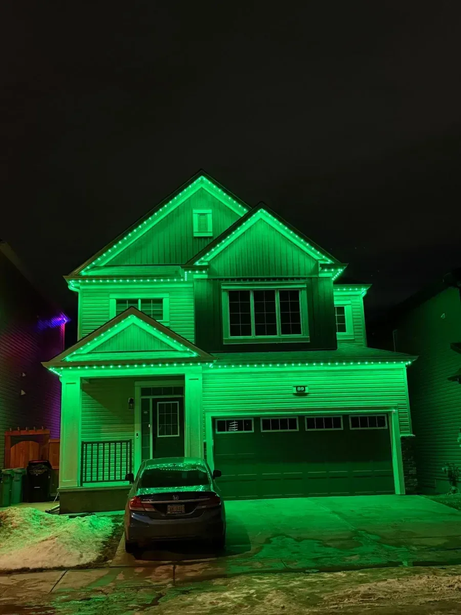 Leduc home illuminated in vivid green with the Prairie Lighting system
