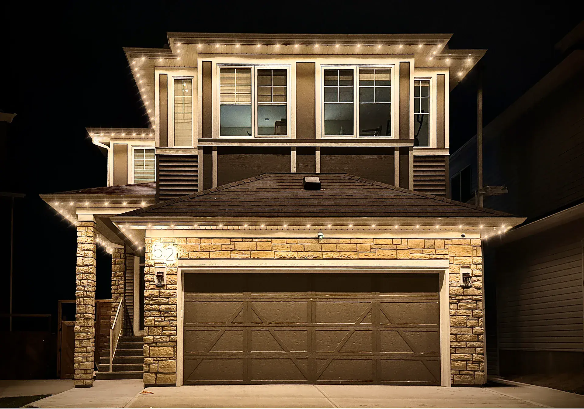 Warm white permanent LED lighting on an Edmonton home at night