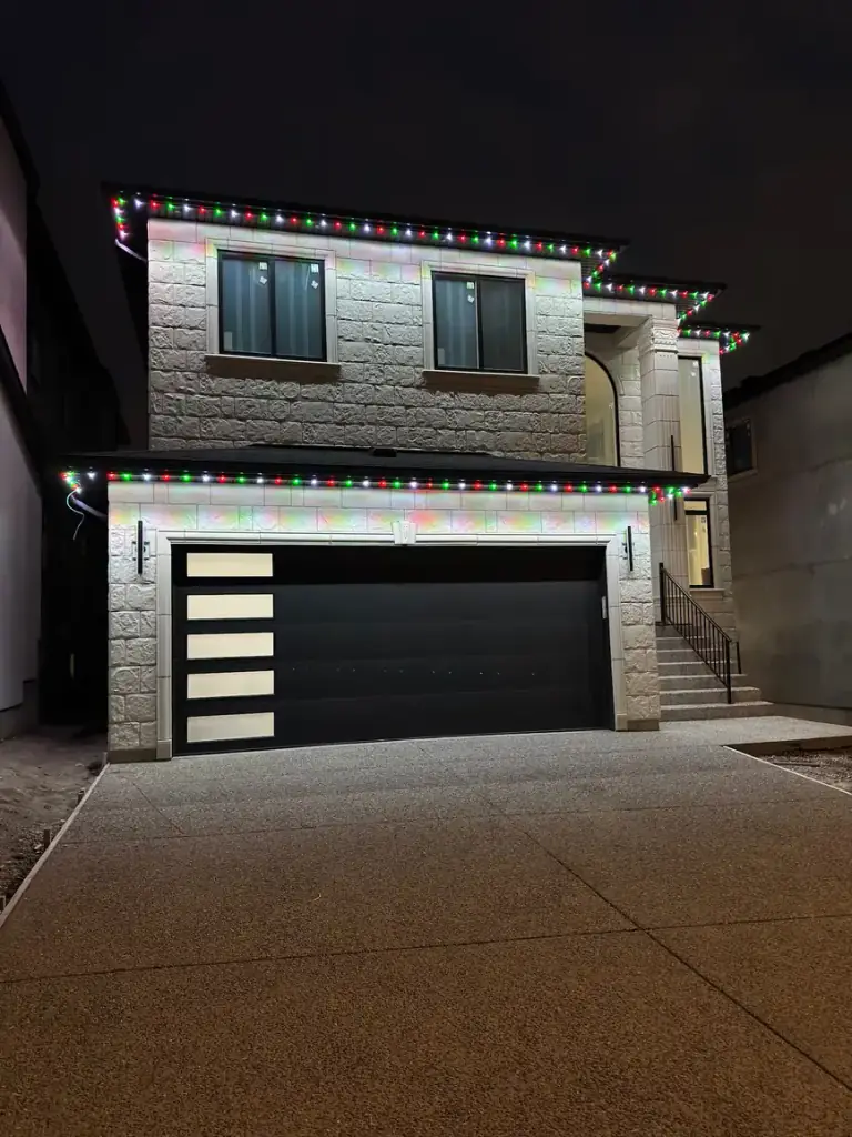 Christmas multicolor permanent LED lighting on stone Edmonton home