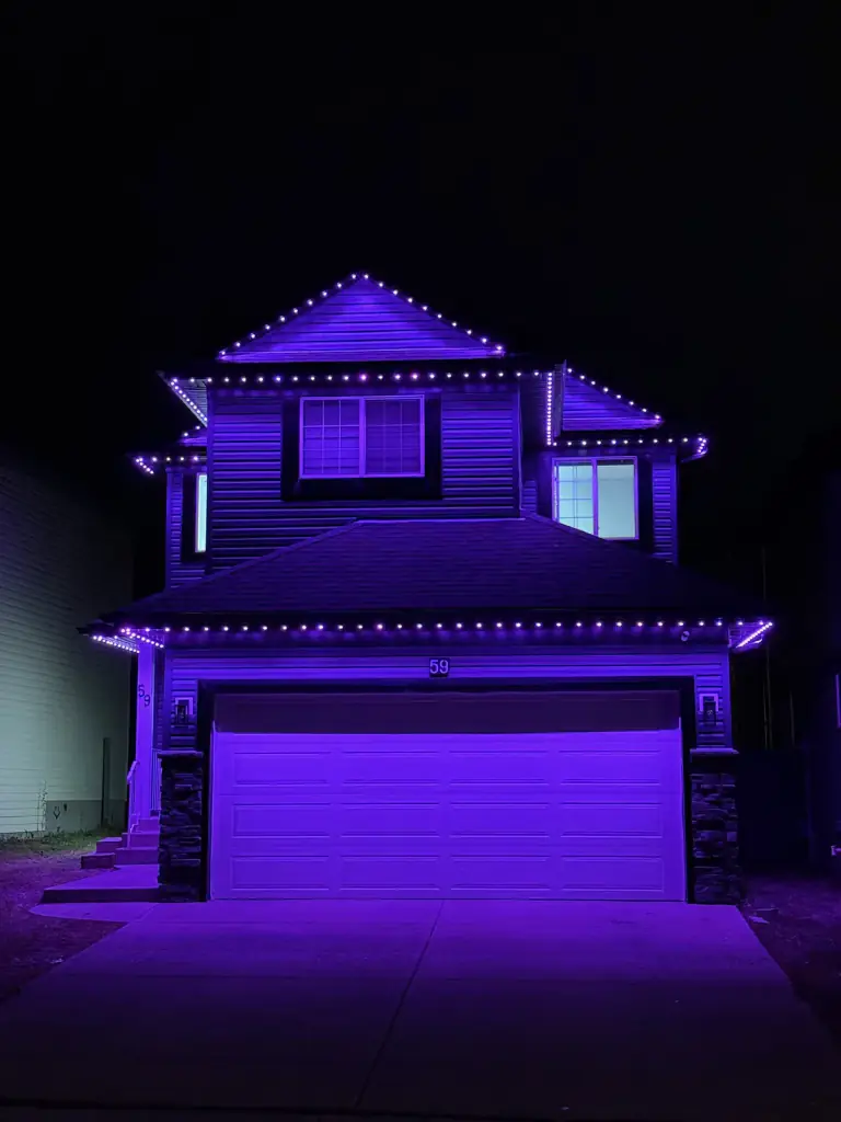 Purple permanent LED lighting on Edmonton home at night