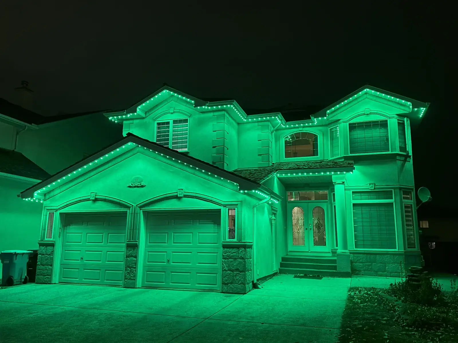 Green permanent outdoor lights on a Kelowna home at night