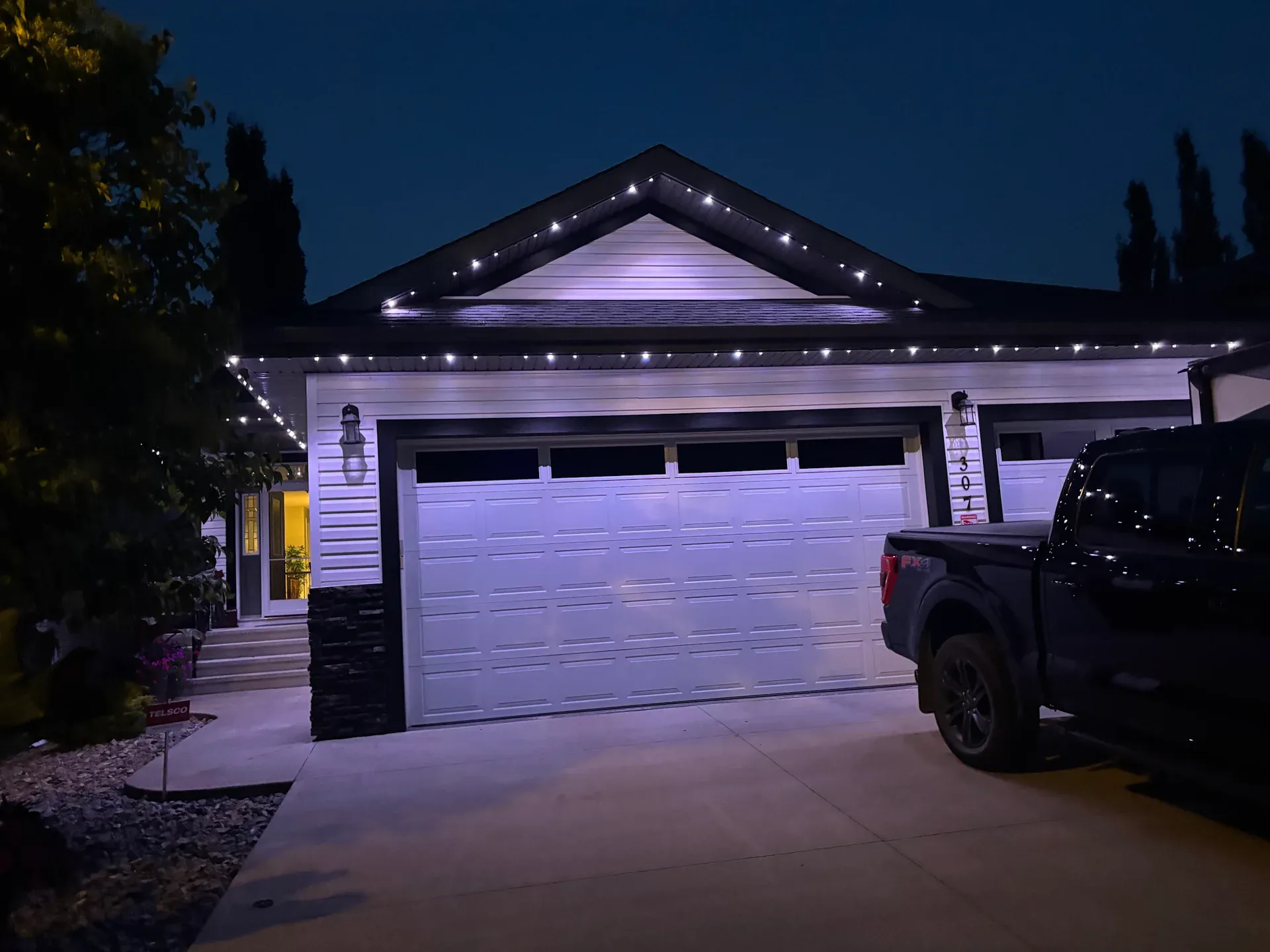Permanent Christmas lights installed on a single-storey bungalow in Edmonton