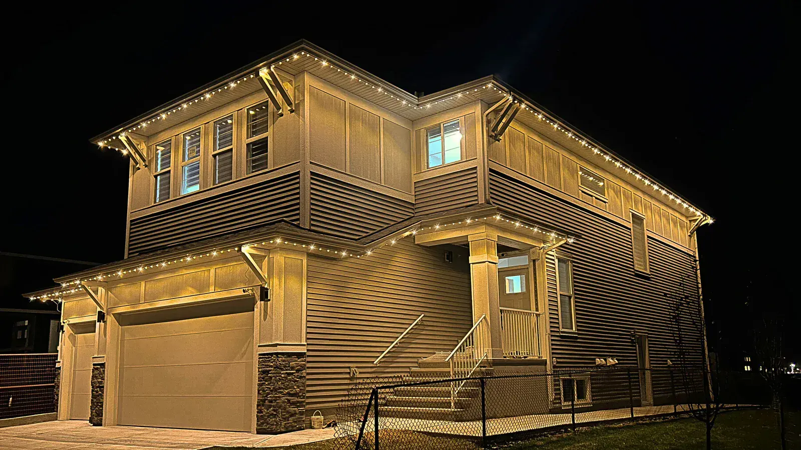 Edmonton home with finished permanent soffit lighting glowing at night