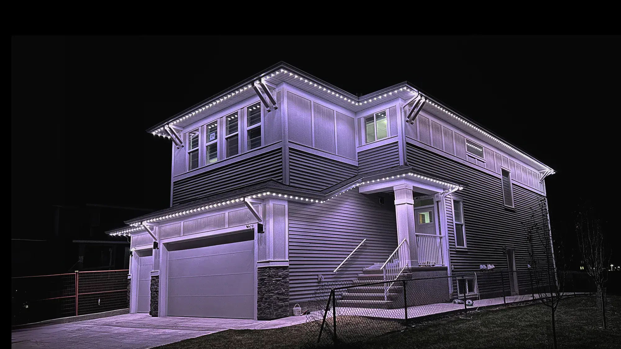 Two-storey Edmonton home with warm-white permanent Christmas lights