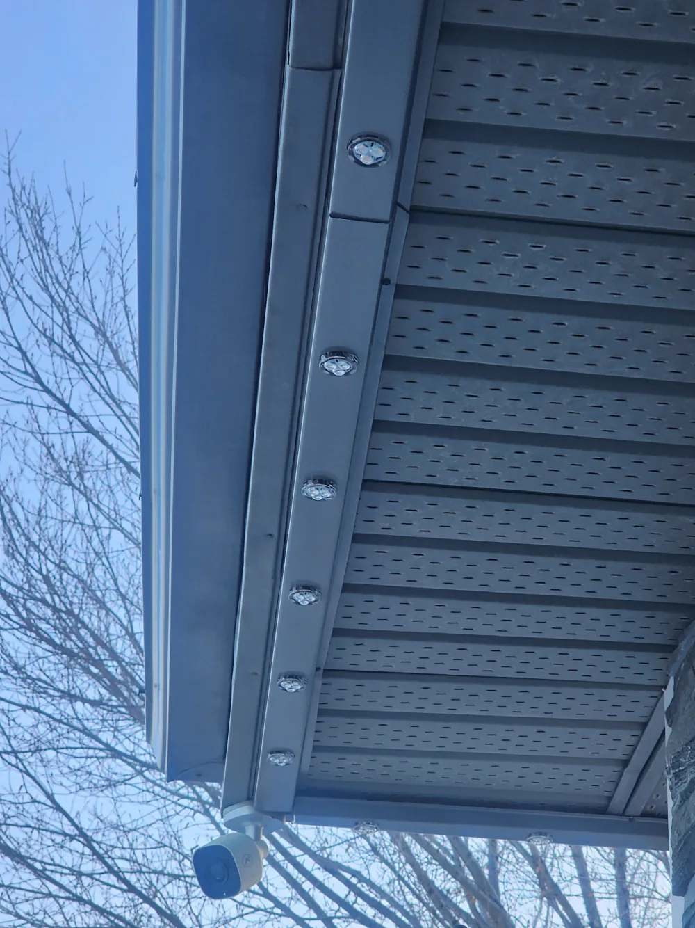 Prairie Lighting colour-matched aluminum track installed beneath a grey home soffit