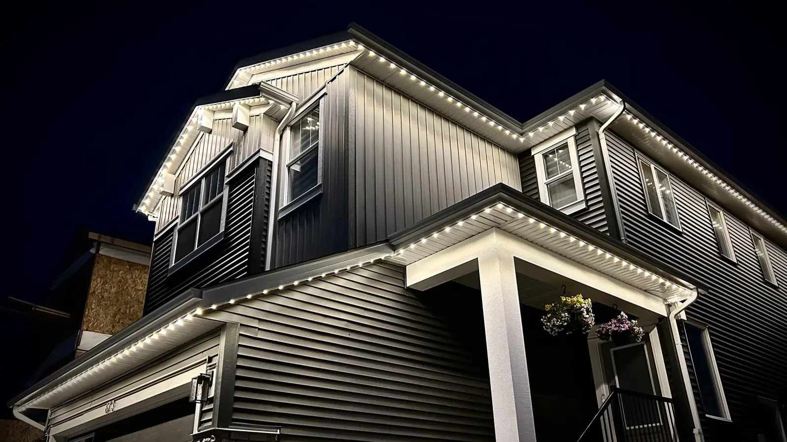 Permanent soffit and architectural lighting on Edmonton home at night